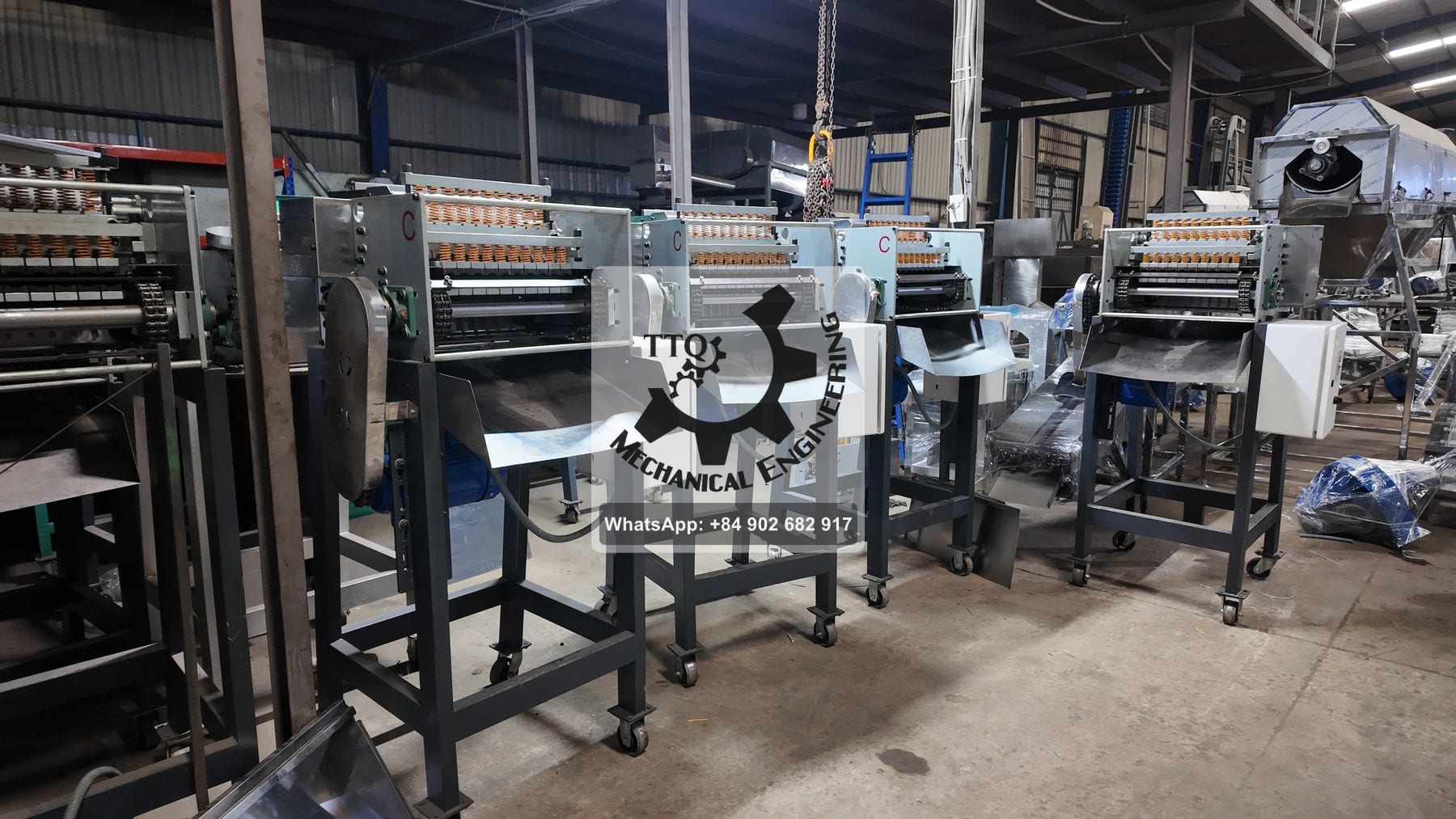 A row of cashew cutting machines in build, each on its own stand